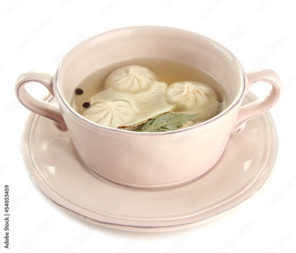 Tasty khinkali in .saucepan, isolated on white