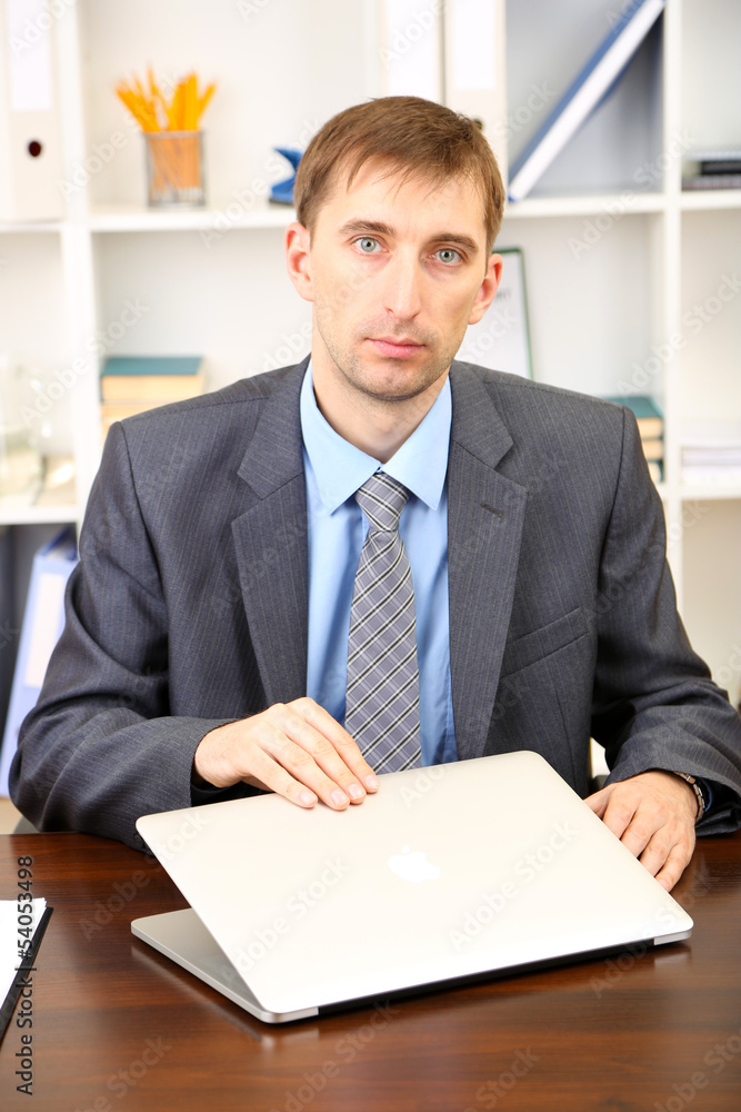 Young businessman with laptop computer shouting down Young businessman with laptop computer shouting down