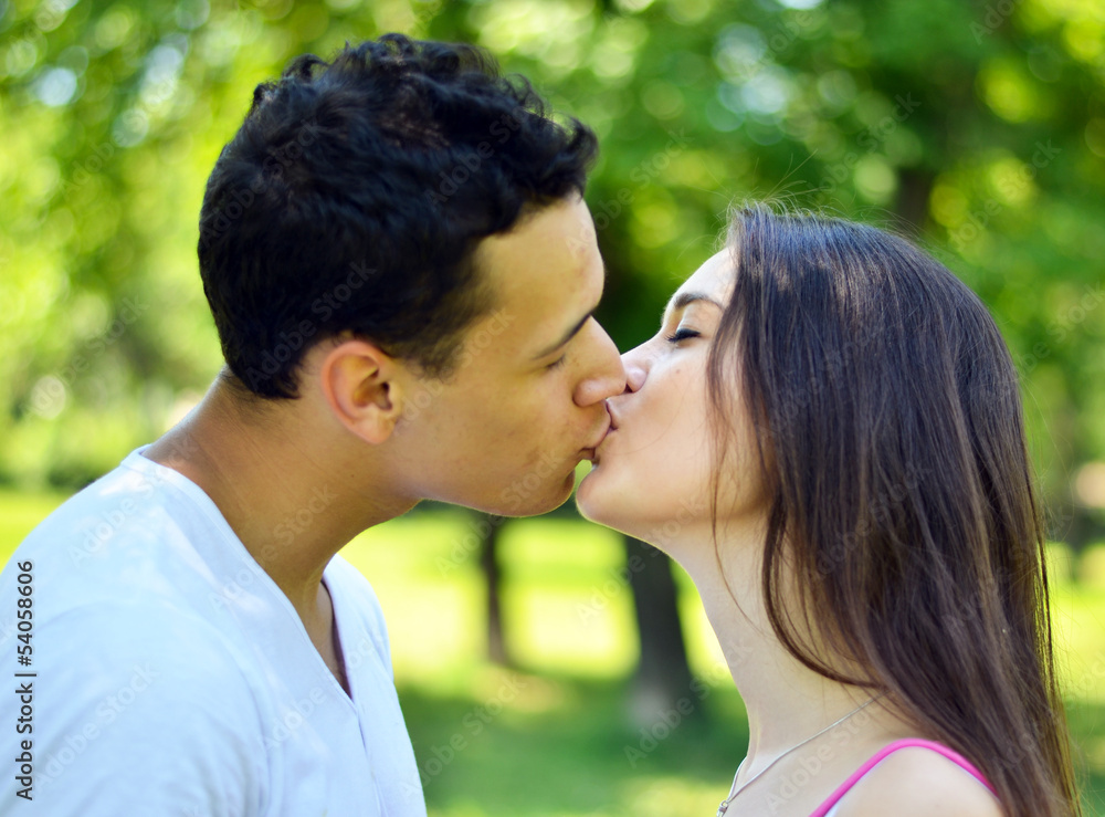 Young couple kissing outdoor Young couple kissing outdoor
