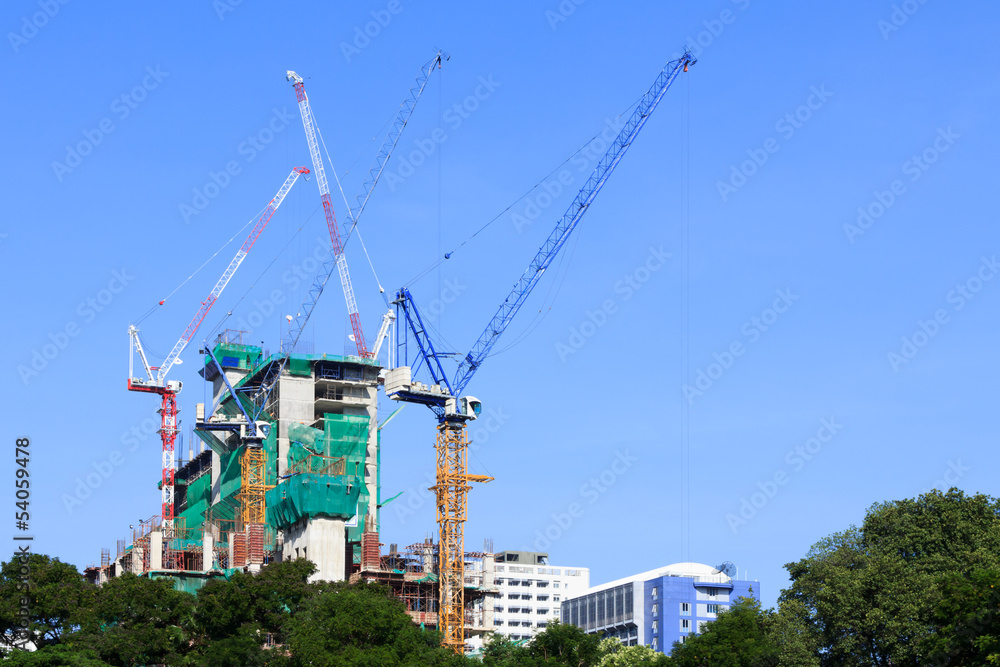 Construction site and tower cranes with blue sky