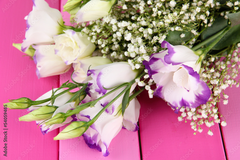 Bouquet of eustoma flowers on color wooden background Bouquet of eustoma flowers on color wooden background