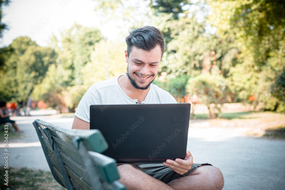 young stylish man using notebook young stylish man using notebook