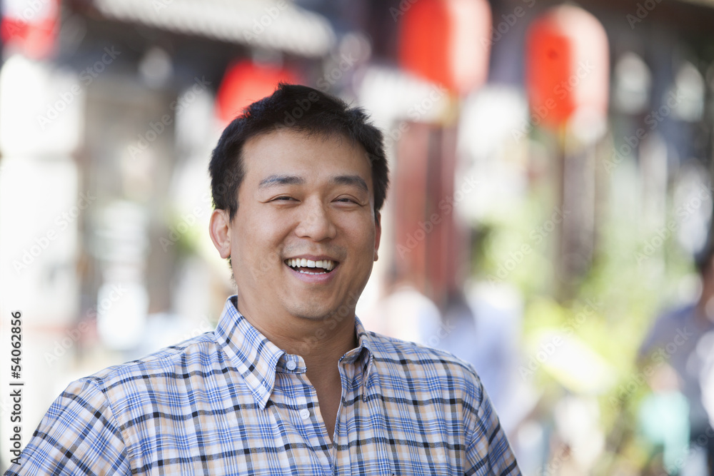 Laughing Mid Adult Man in Nanluoguxiang, Beijing Laughing Mid Adult Man in Nanluoguxiang, Beijing