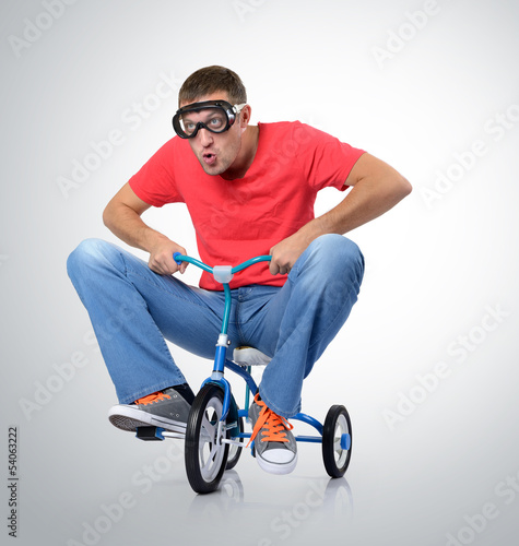 The curious man on a children's bicycle photo