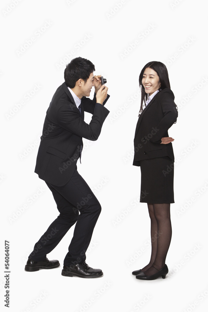 Businessman photographing businesswoman Businessman photographing businesswoman