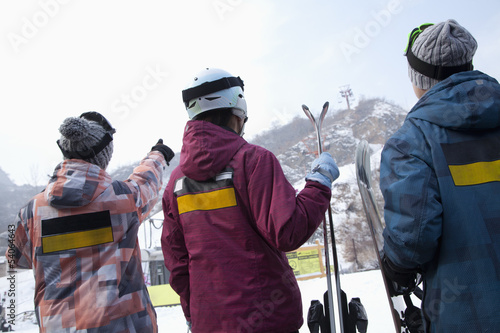 Group of People Pointing at Hill in Ski Resort