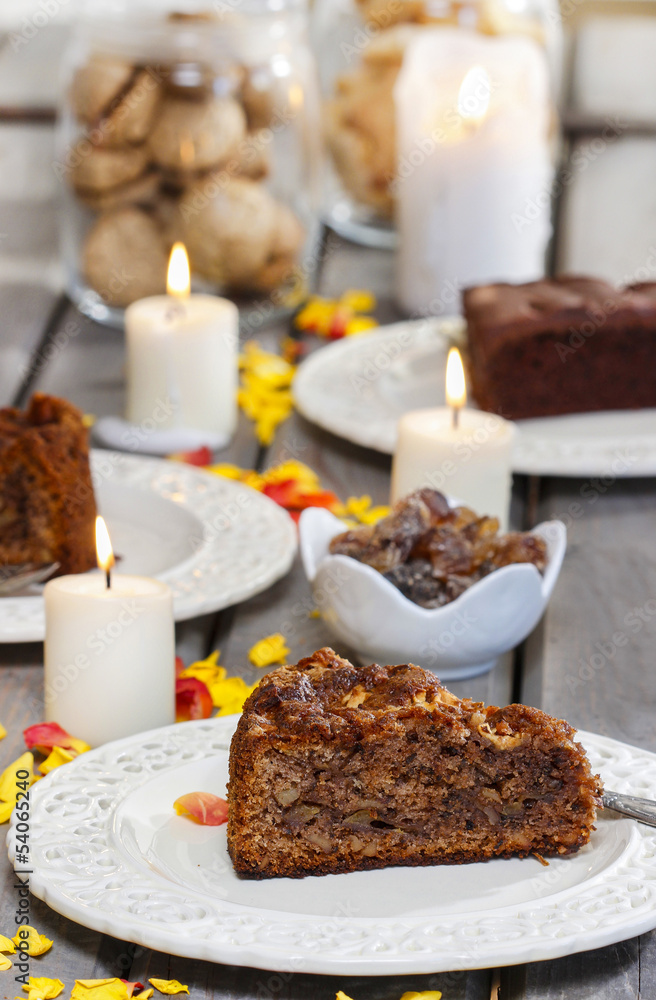 Chocolate cake, beautiful party table setting with candles and r Chocolate cake, beautiful party table setting with candles and r