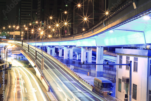 Large urban highway viaduct light trails night scene