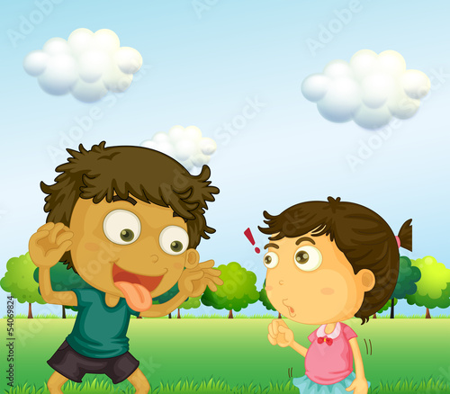 A boy annoying a little girl