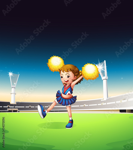 A pretty young cheerleader at the field