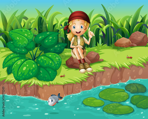 A girl sitting at the rock beside the river