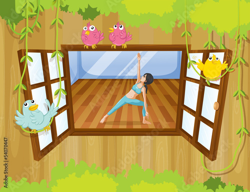 A girl doing yoga near the window