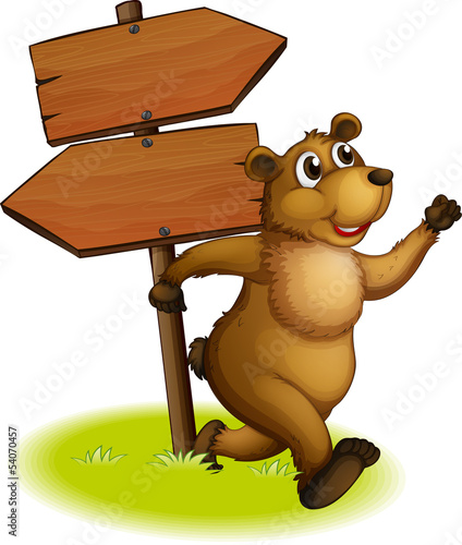 A bear running with a wooden arrow board at the back