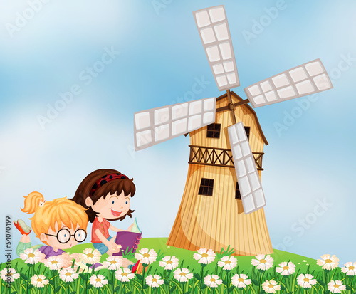Girls reading at the hilltop near the barnhouse