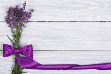 floral frame from flowers of lavender and purple ribbon