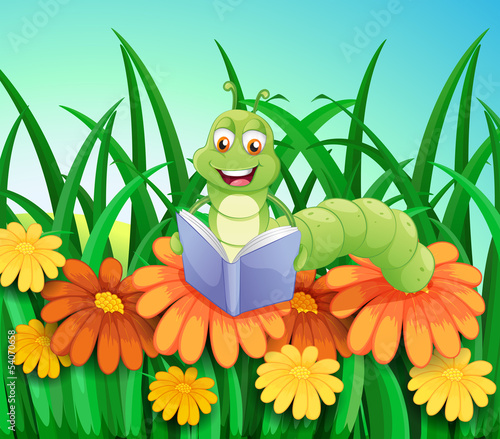 Fototapeta Naklejka Na Ścianę i Meble -  A worm reading a book at the garden