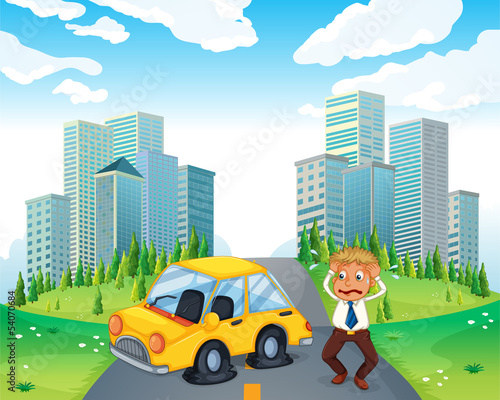 A worried owner of a car with flat tires