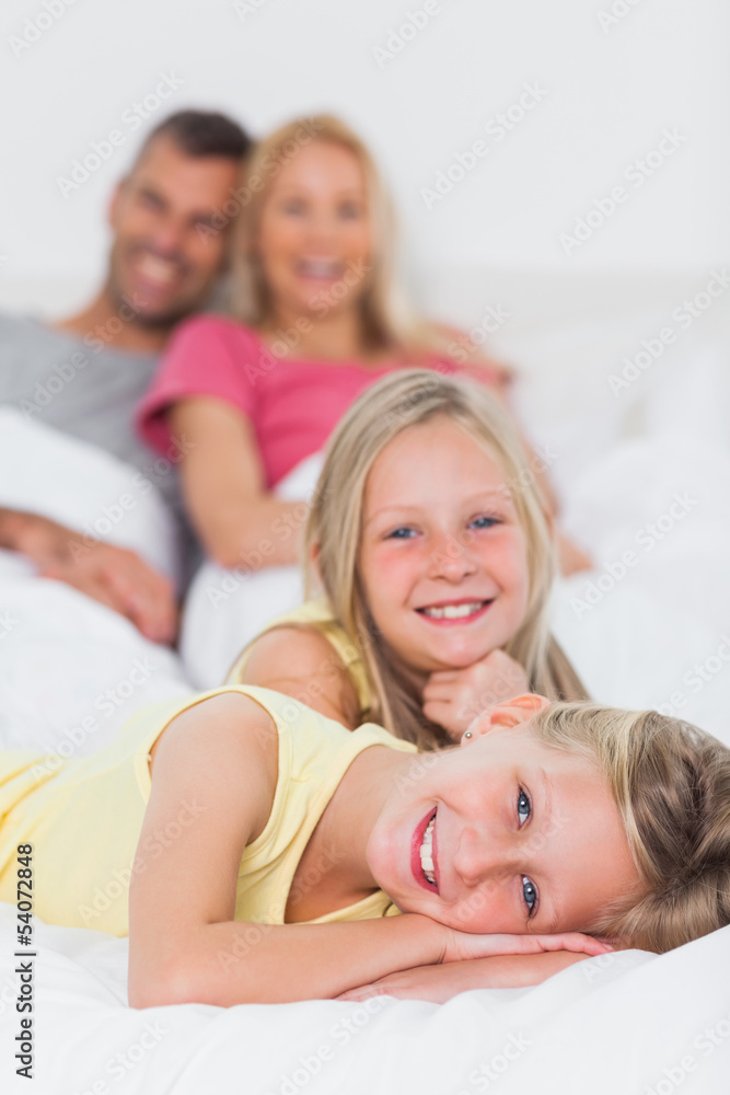 Cute twins posing in bed in front of their parents