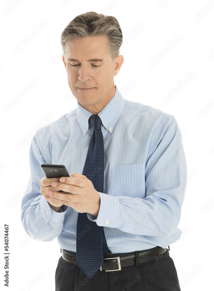 Mature Businessman Text Messaging Through Mobile Phone Mature Businessman Text Messaging Through Mobile Phone