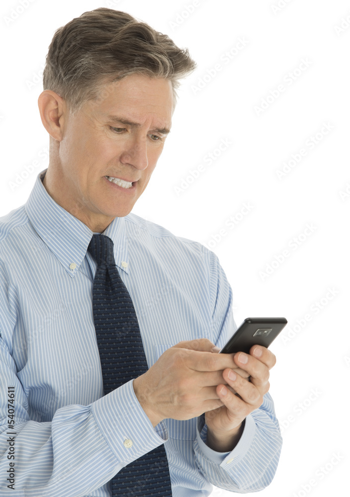 Angry Businessman Messaging Through Mobile Phone Angry Businessman Messaging Through Mobile Phone