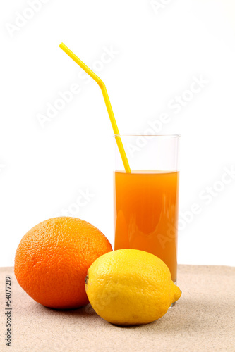 Juice  orange  lime on sand.
