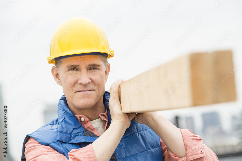Confident Manual Worker Carrying Wooden Plank Confident Manual Worker Carrying Wooden Plank