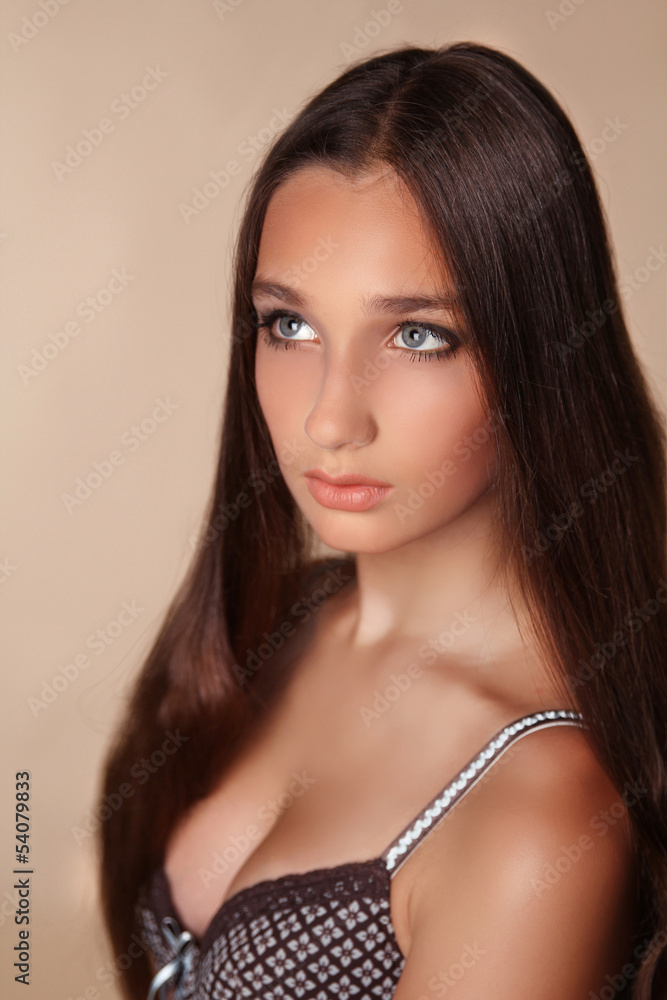 Long Hair. Beauty Woman with Healthy Shiny Smooth Brown Hair. Mo