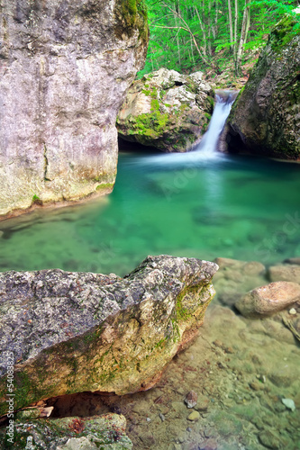 Spring wood and river. Waterfall.