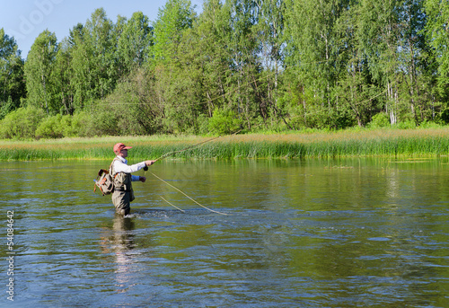 Fisherman catches of chub  fly fishing in the Chusovaya river photo