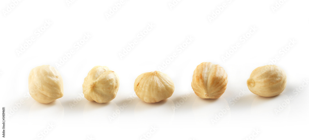 Closeup view of hazelnuts over white background Closeup view of hazelnuts over white background