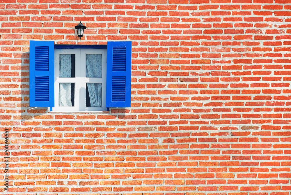 Blue windows on brick wall background