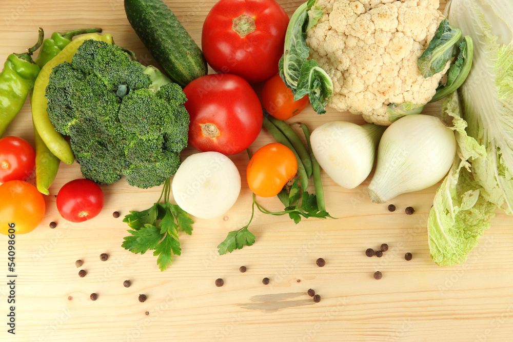 Fresh vegetables in basket on wooden table close-up Fresh vegetables in basket on wooden table close-up