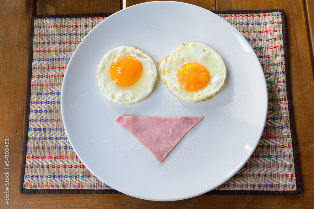 breakfast smiley face with bacon and fried eggs on white plate breakfast smiley face with bacon and fried eggs on white plate