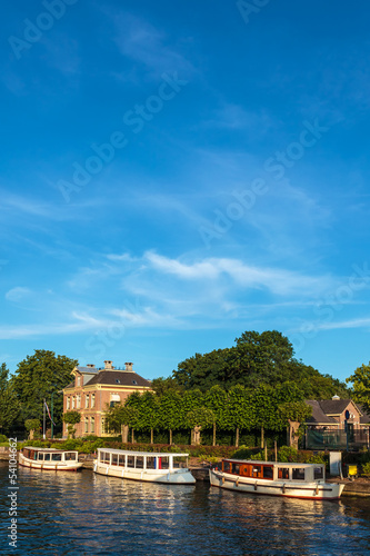 Classic small cruise boats on the famous Dutch river Vecht