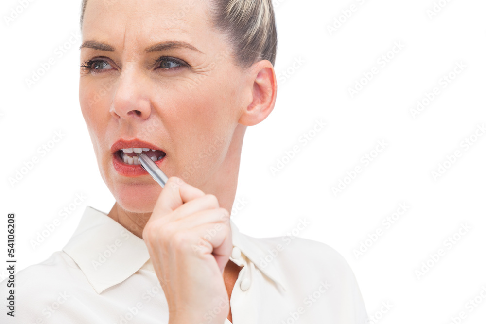 Businesswoman thinking with pen on mouth Businesswoman thinking with pen on mouth