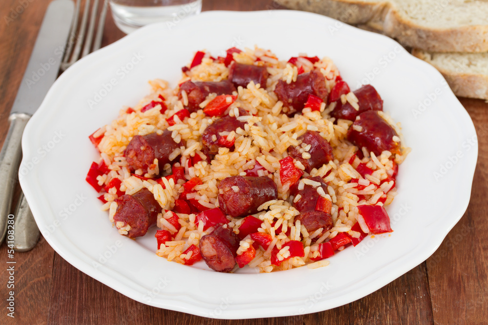 rice with sausages and pepper on the white plate rice with sausages and pepper on the white plate