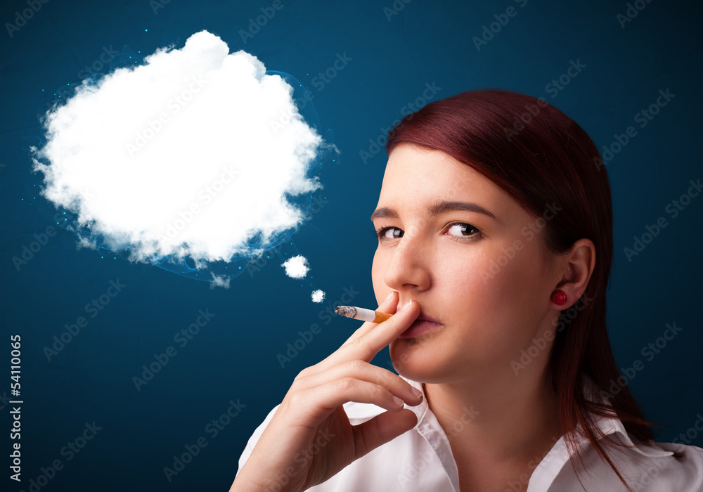 Fototapeta premium Young woman smoking unhealthy cigarette with dense smoke