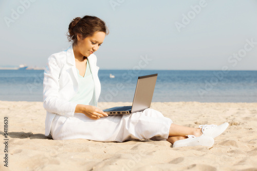 Young businesswoman on the beach