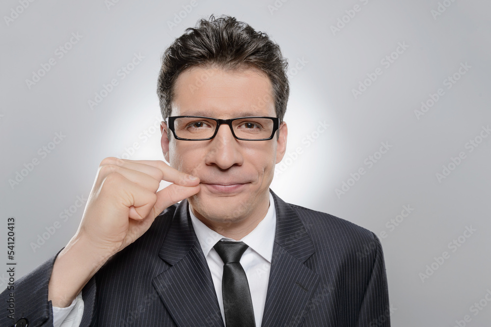 No more word. Portrait of confident businessman holding his fing No more word. Portrait of confident businessman holding his fing