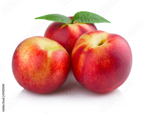 Three ripe peach (nectarine) fruits isolated