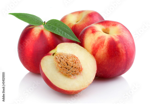 Three ripe peach (nectarine) fruits with slices isolated
