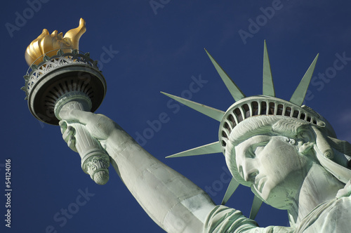 Close-up Portrait of Statue of Liberty Bright Blue Sky Torch