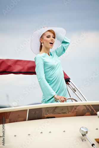 Fashion woman with steering wheel showing thumb up on the yacht © ZoomTeam