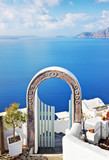 Beautiful arched gateway above aegean sea in Oia