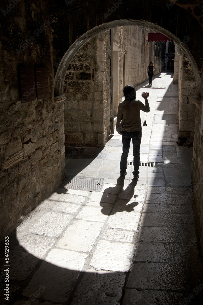 Young girl in narrow mediterranean street in Split, Croatia
