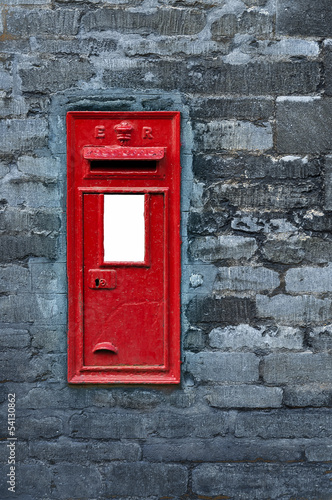 Red post box set in wall