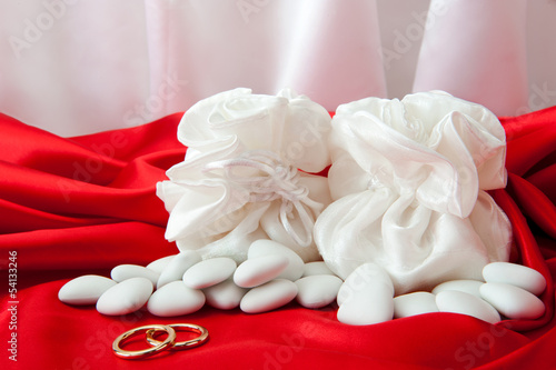  wedding rings and  favors on elegant  fabric
