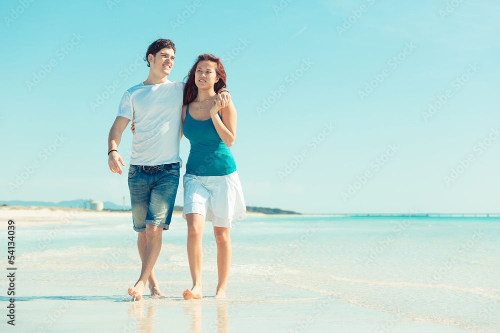 Young Couple Walking on a Caribbean Beach