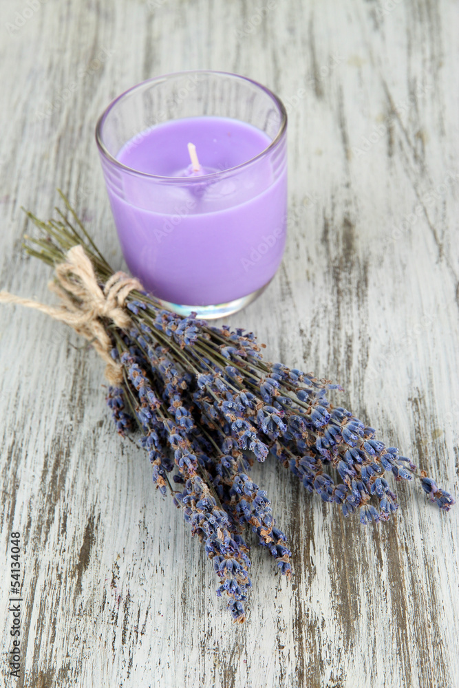 Lavender candle with fresh lavender, on wooden background Lavender candle with fresh lavender, on wooden background