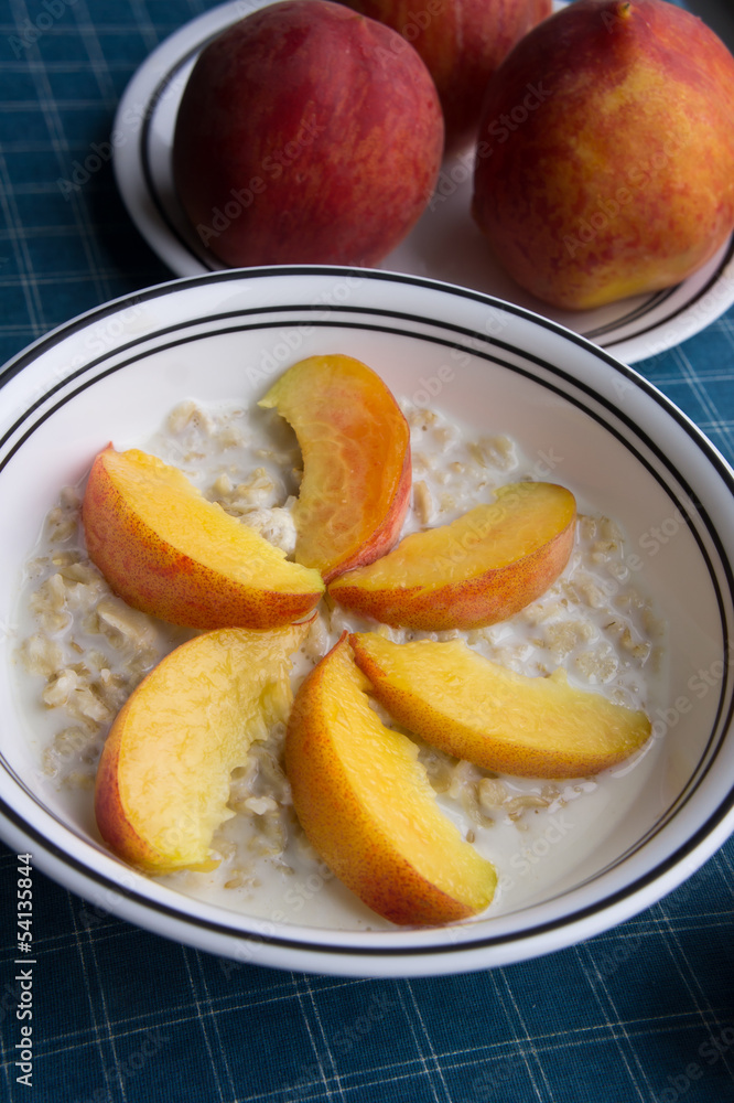 Peaches oatmeal on a blue tablecloth served